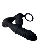 Close-up of vibrating end of prostate massager and cock ring with remote leaning on the product