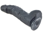 Black FAAK curved dildo left side laying on ground